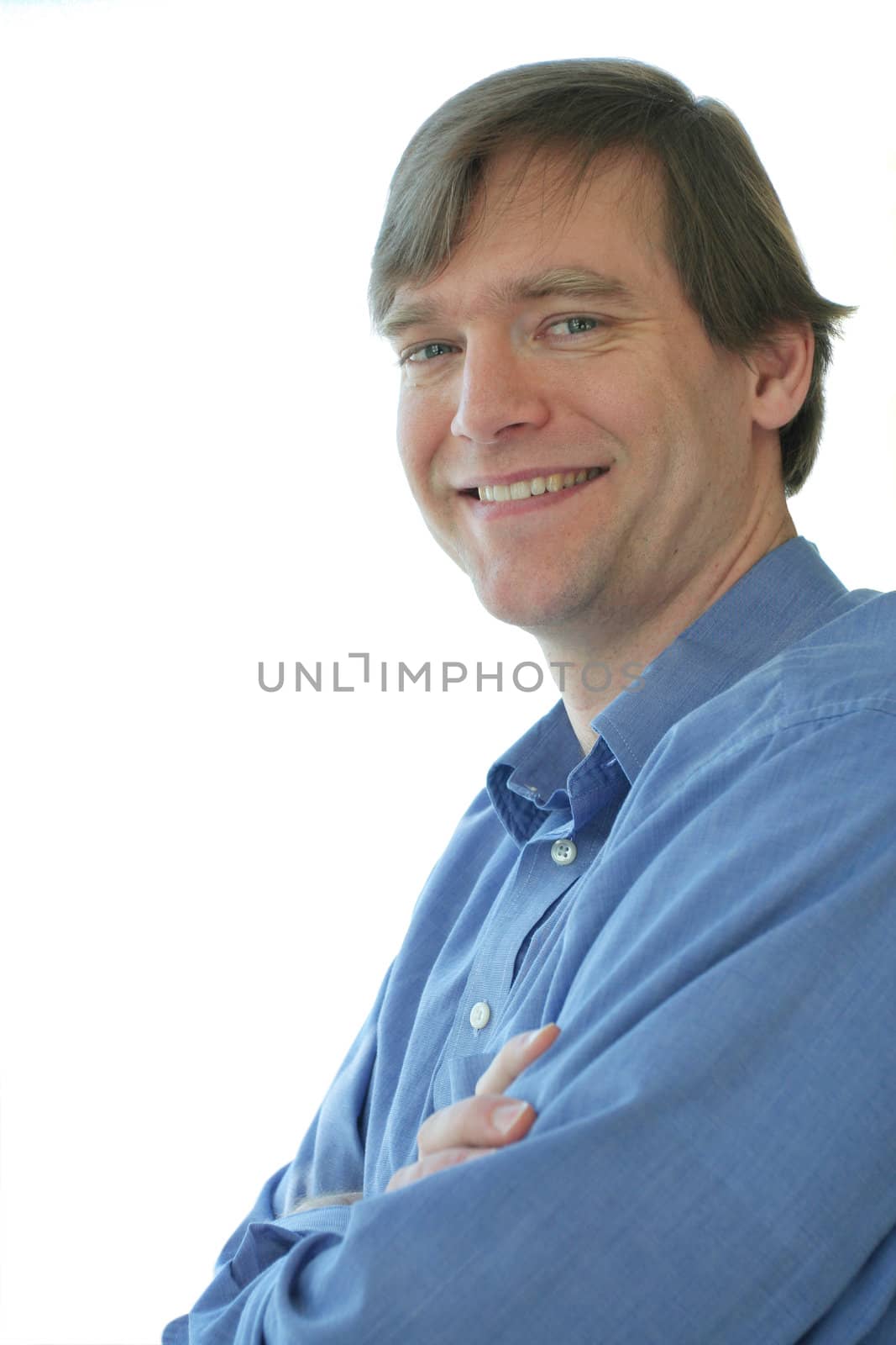 Handsome business man standing arms crossed, smiling