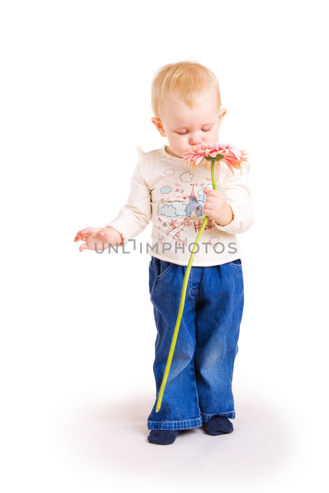 little girl smells flower