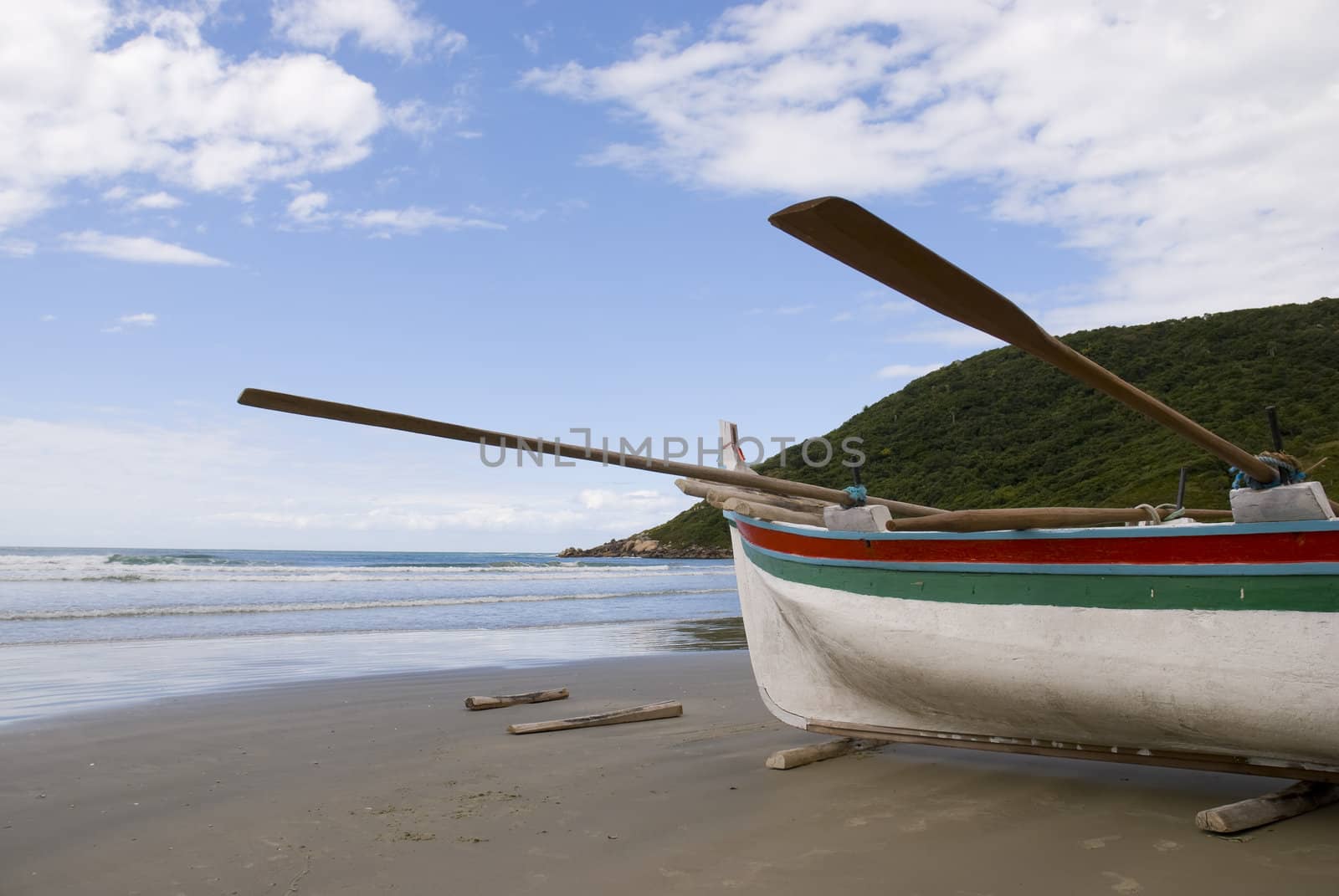 Deserted beach with empty fishing boats in the sand.