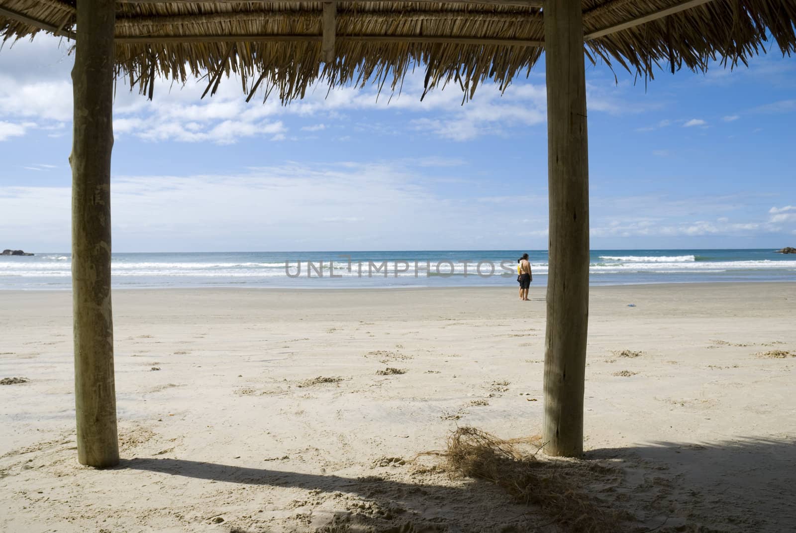 First person view of beach, shot from inside a hay shed.