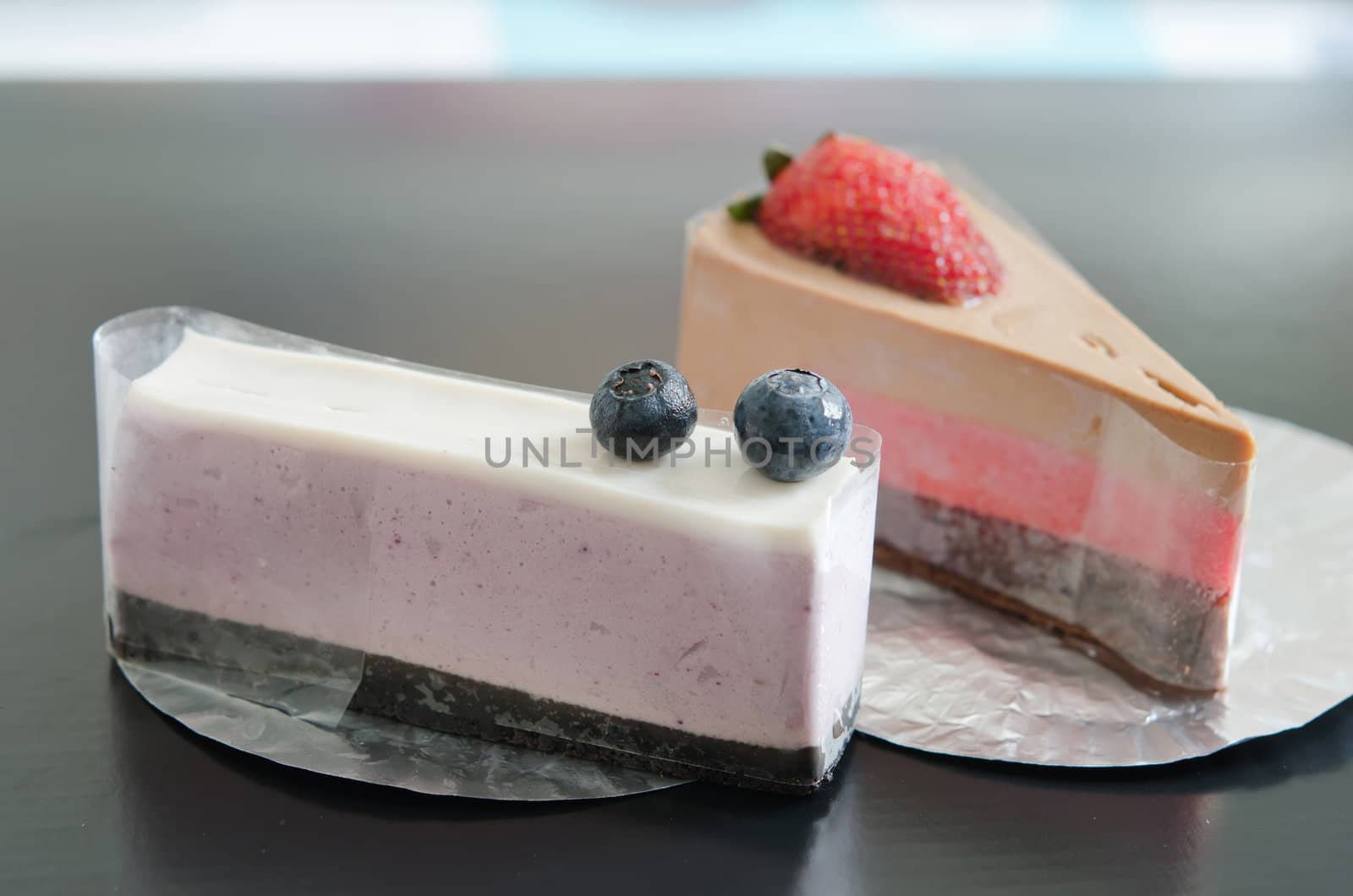 close up blueberries cheesecake and strawberry cheesecake