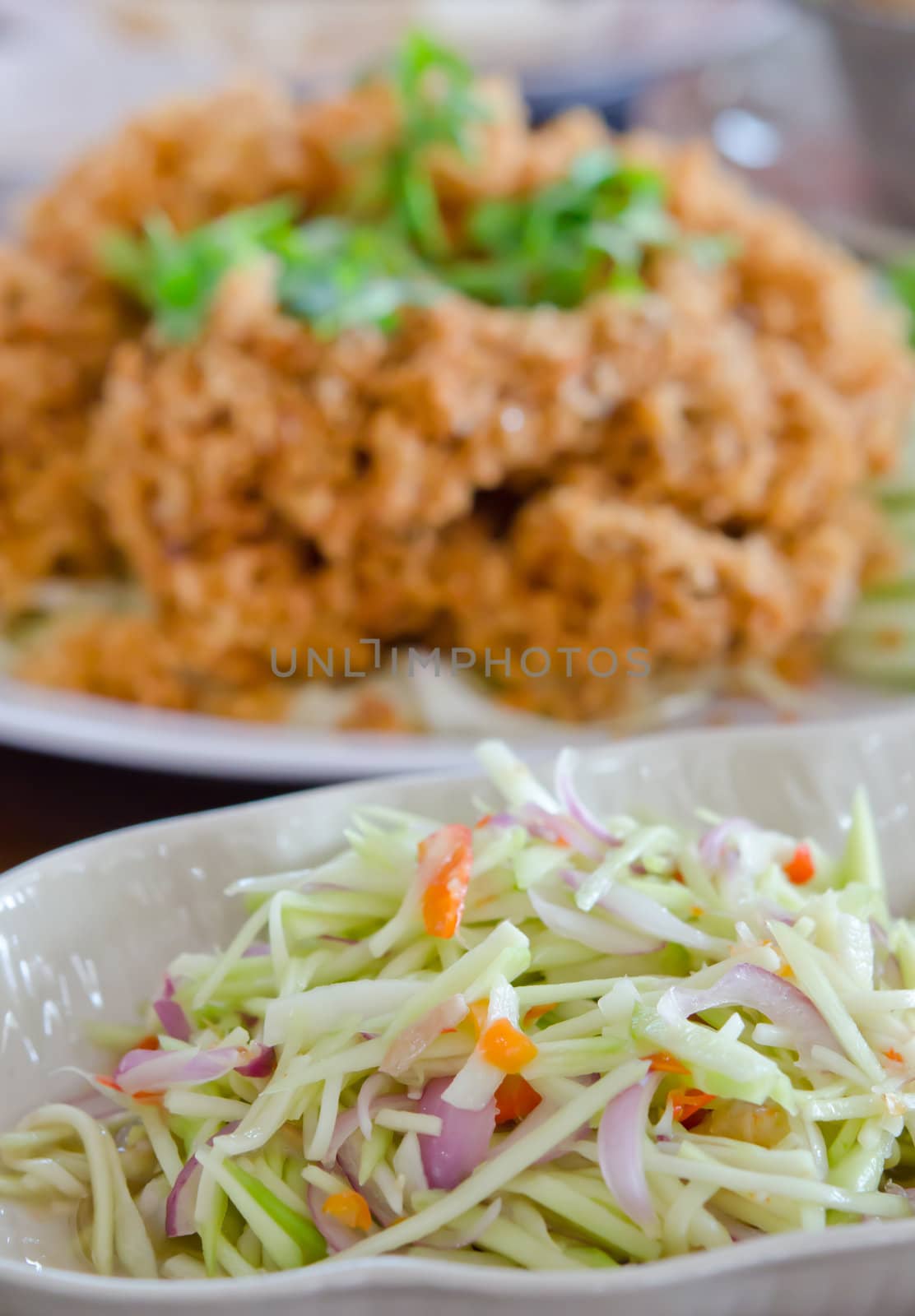 green mango salad  and vegetable served with crispy catfish , spicy and sour