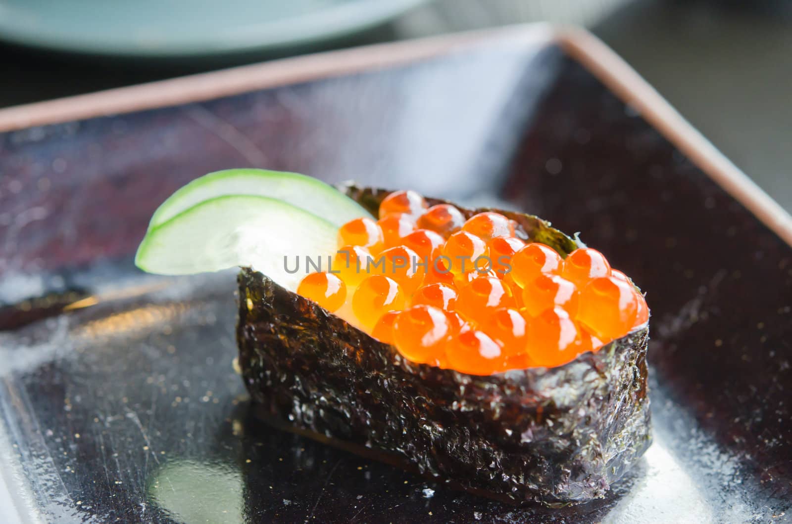 Salmon roe sushi  with cucumber on plate