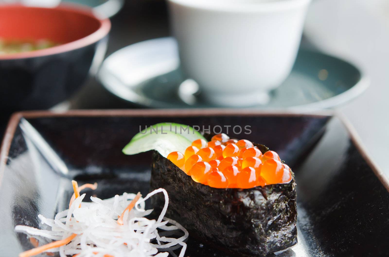 close up Ikura Sushi and slices daikon radishes