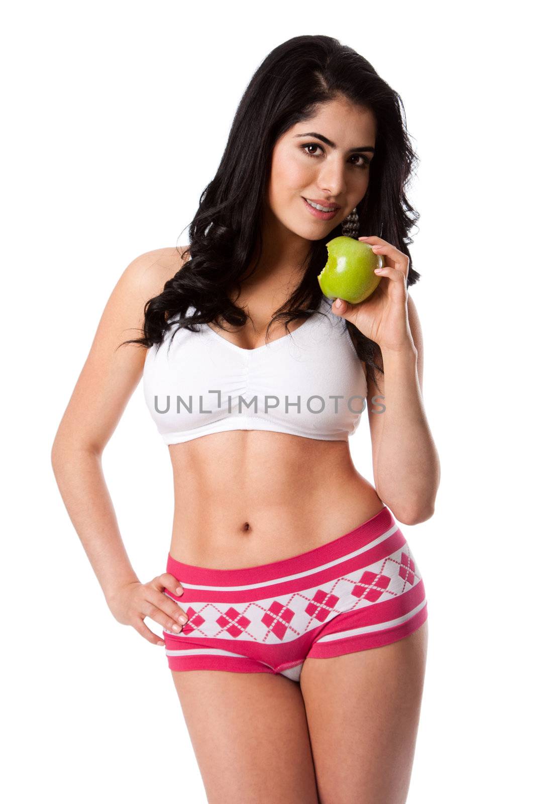 Beautiful happy young woman fit slim in shape with apple for good health standing showing abs and body, weight conscious diet nutrition, isolated.