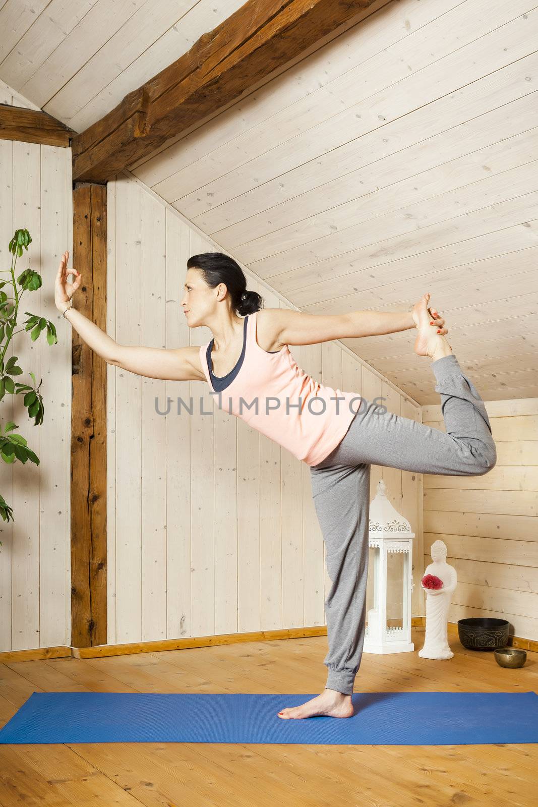 An image of a pretty woman doing yoga at home