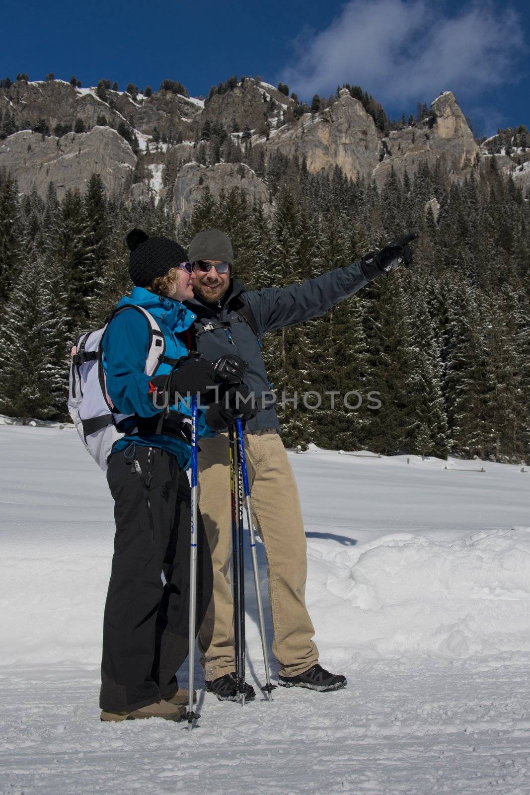 Couple of Hikers Pointing the Way on a snowy Trail by faabi