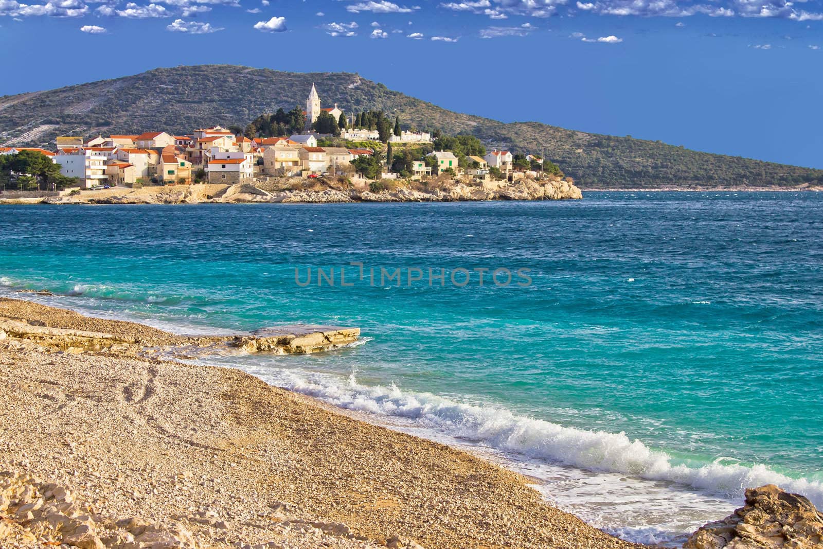 Town of Primosten turquoise sea and pebble beach, Dalmatia, Croatia
