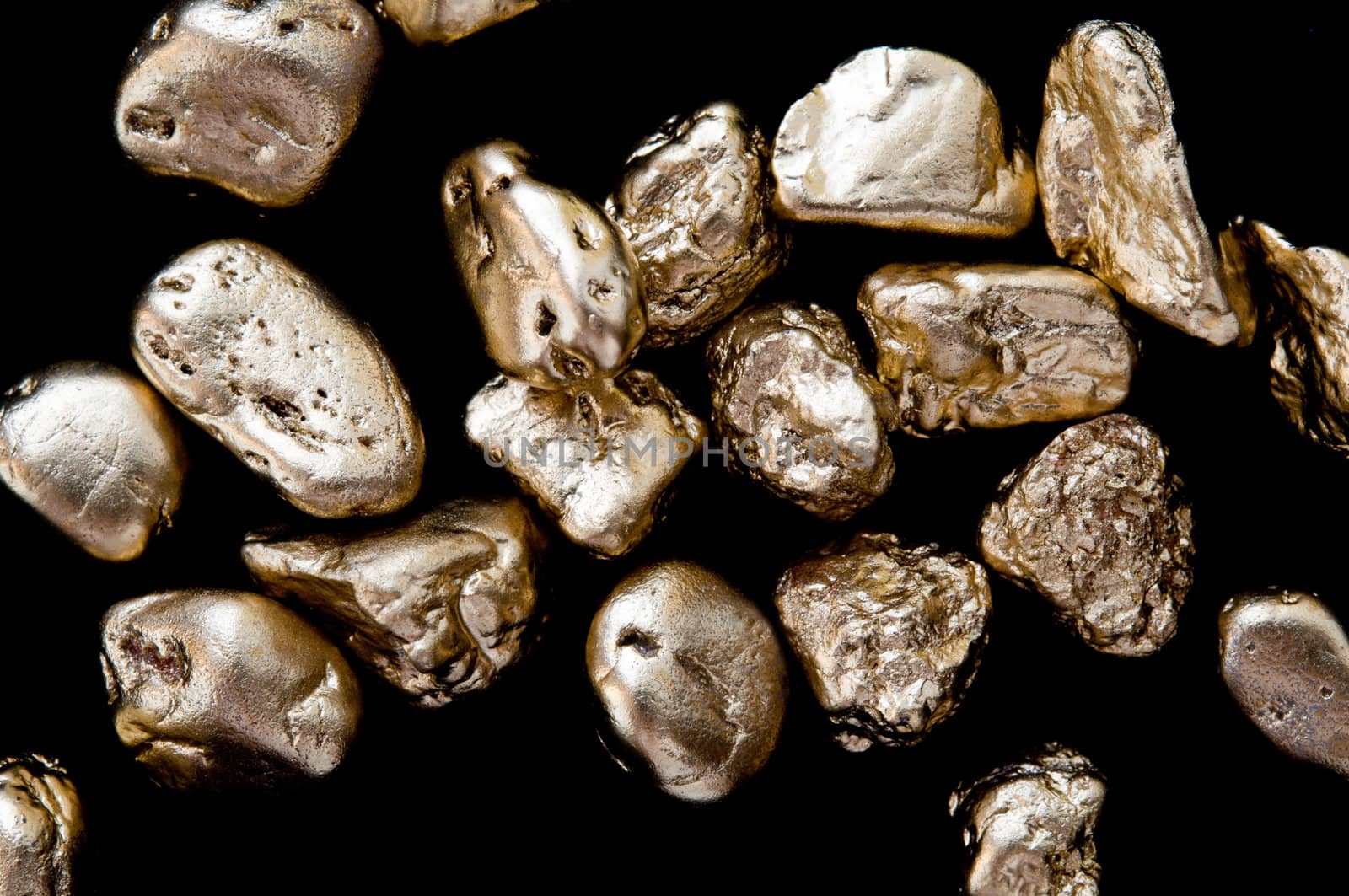 gold nuggets on a black background. closeup.