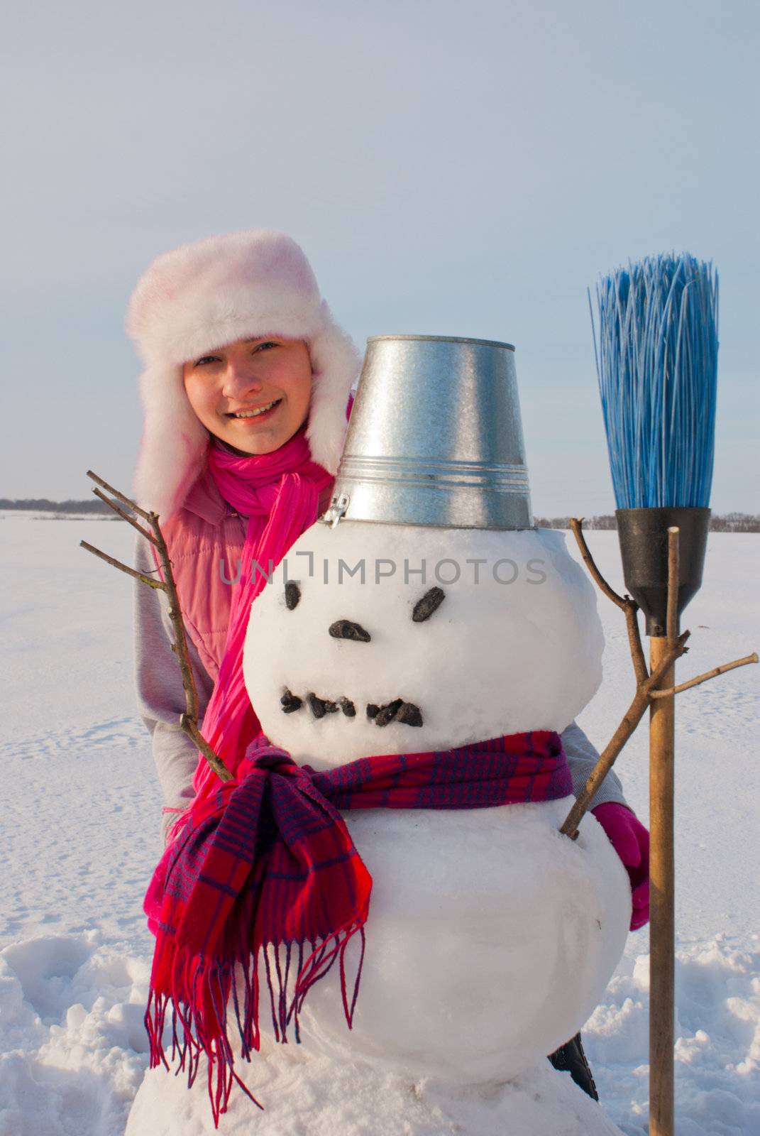 Teenage girl with snowman by AndreyKr