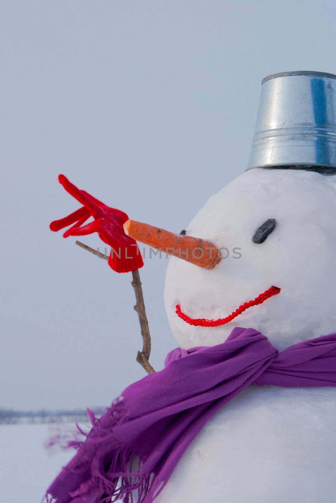 Lonely snowman at a snowy field at winter time