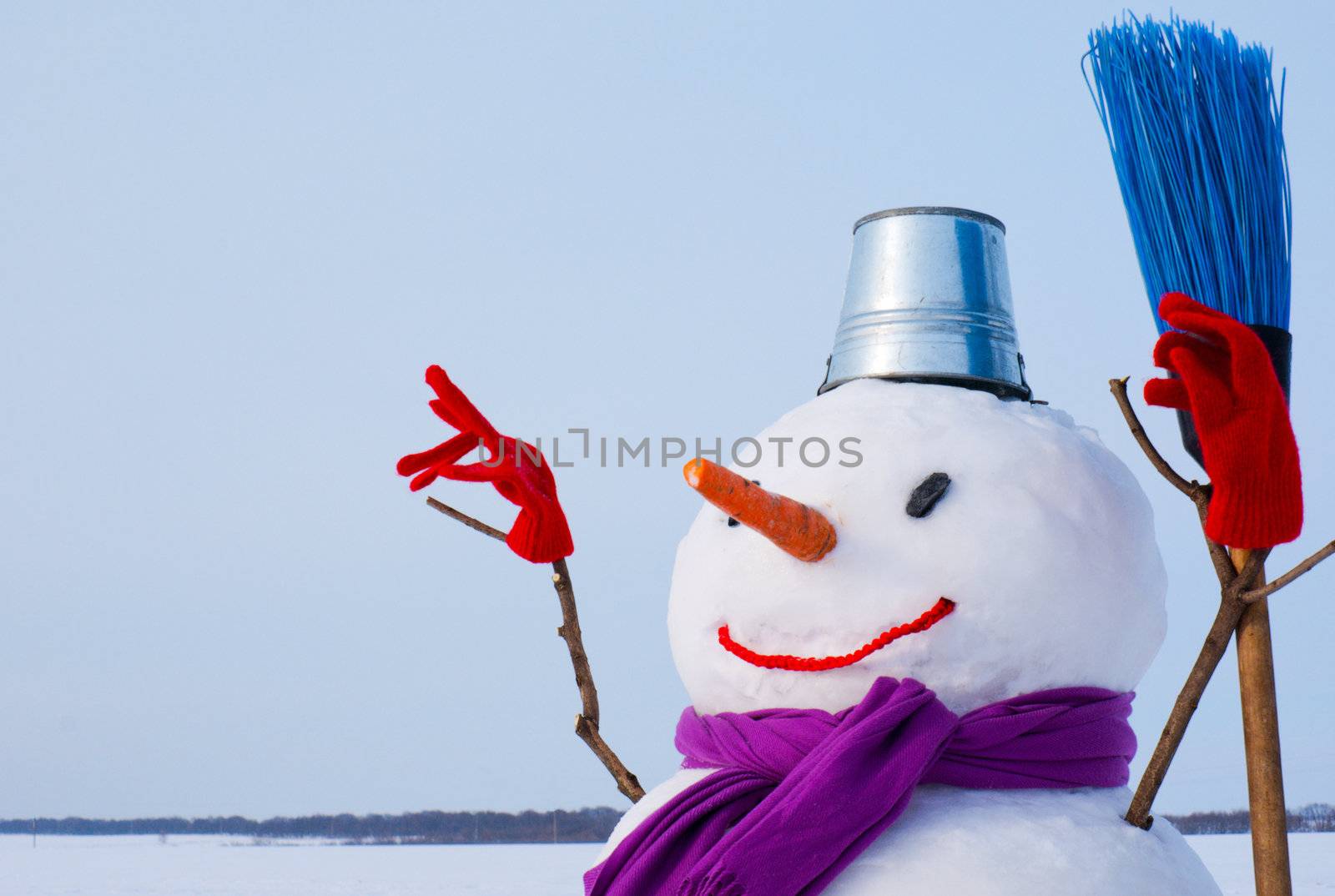 Lonely snowman at a snowy field at winter time