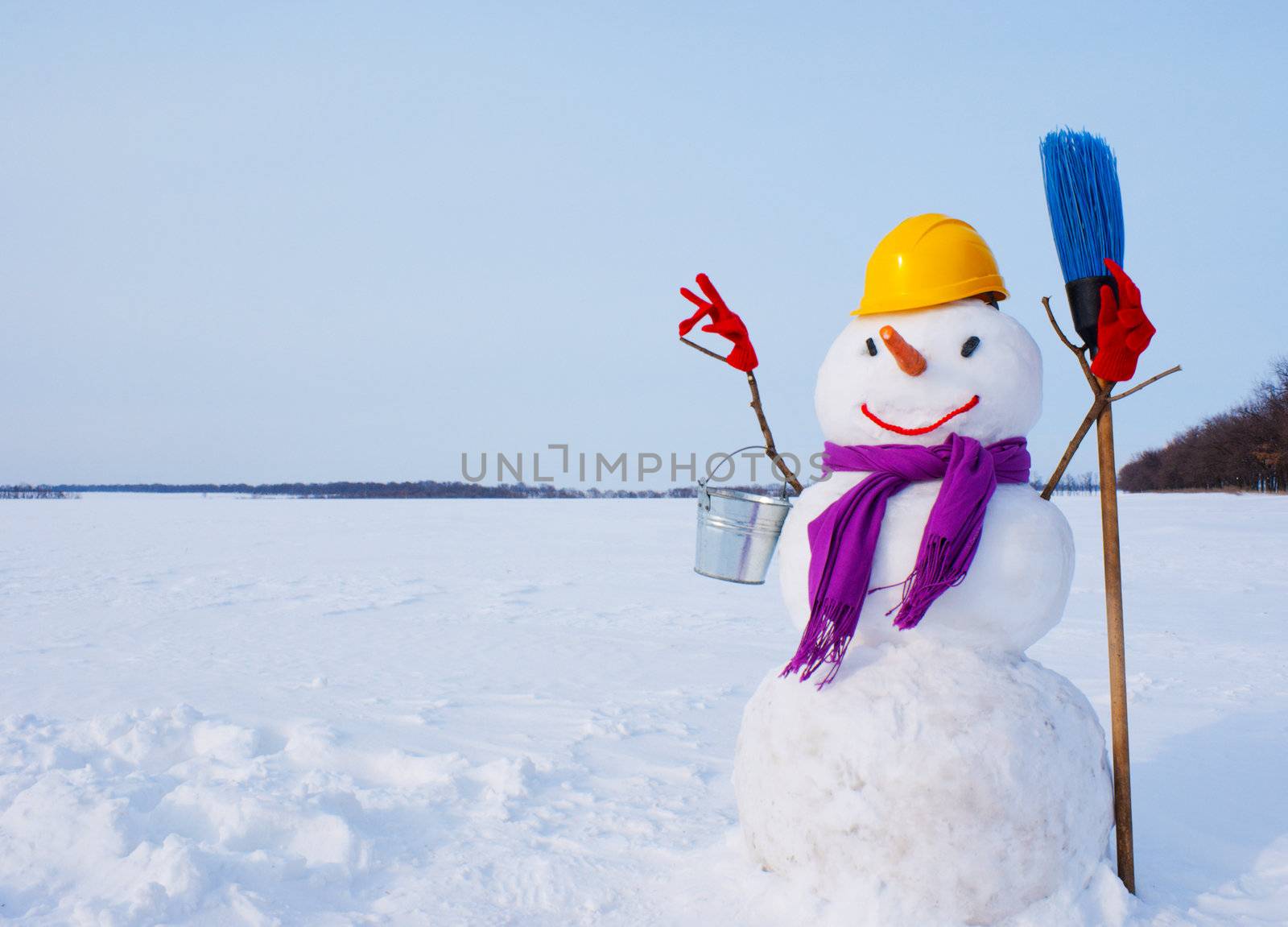 Lonely snowman at a snowy field at winter time