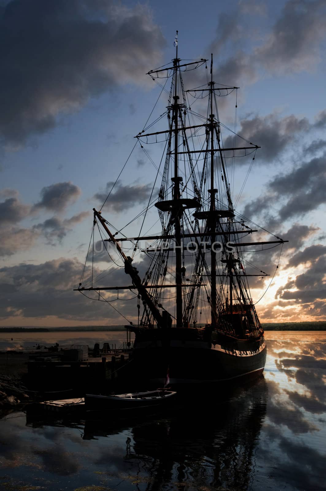 Vintage 18th century sailboat docked in the harbour at sunset in Nova Scotia