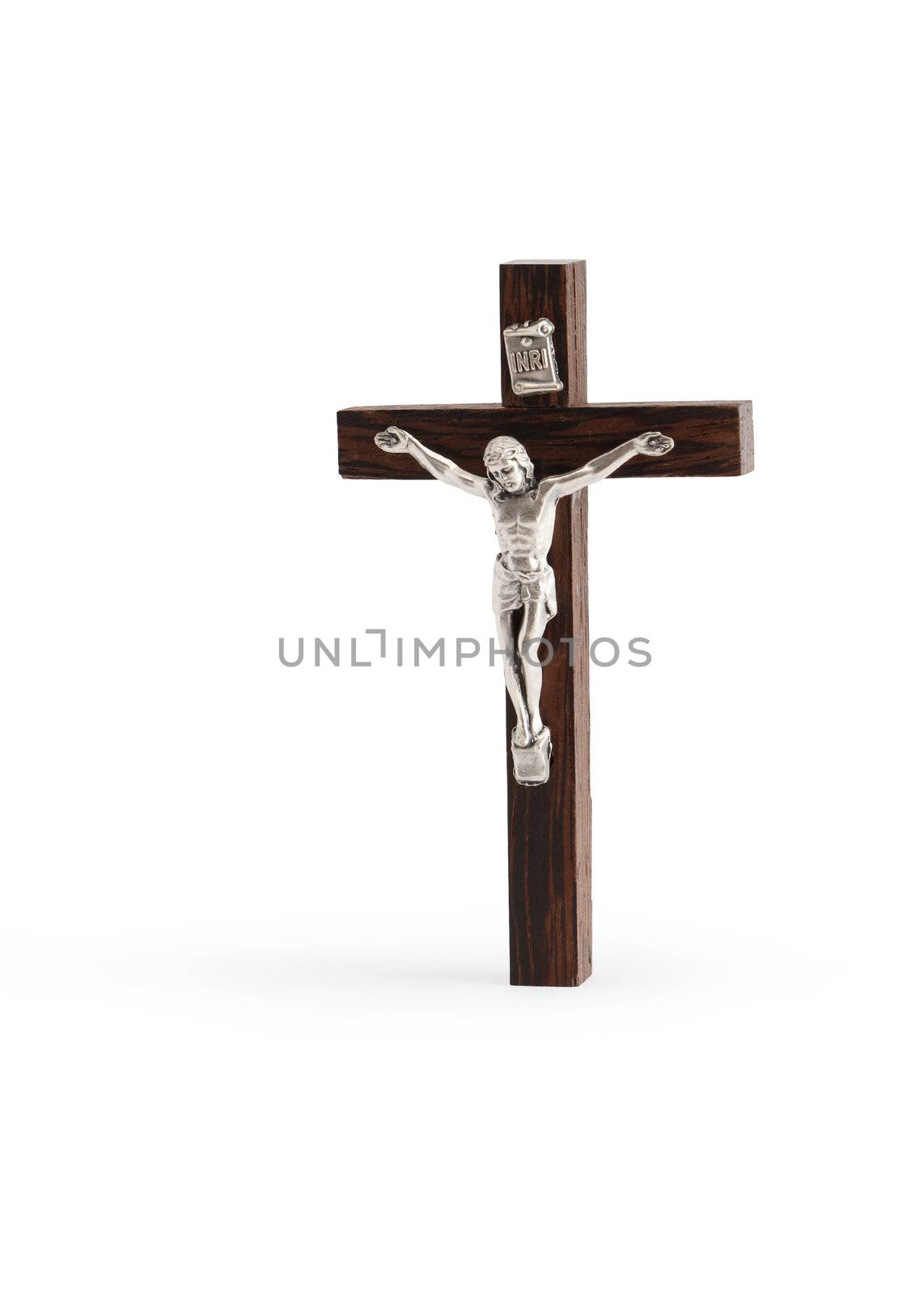 Small wooden crucifix standing on white background. Isolated with clipping path