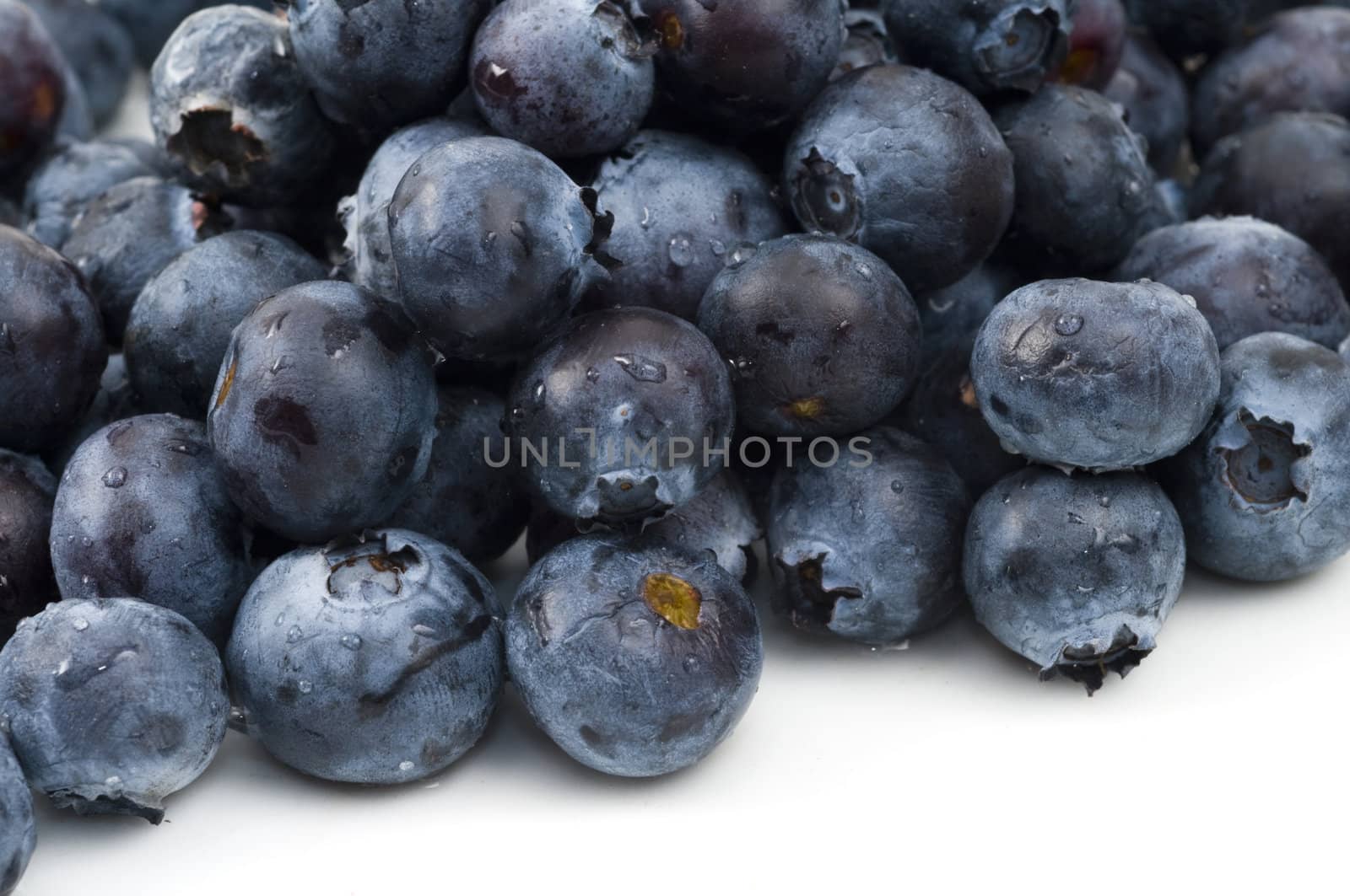 Close-up of a bunch of blueberries on a white background