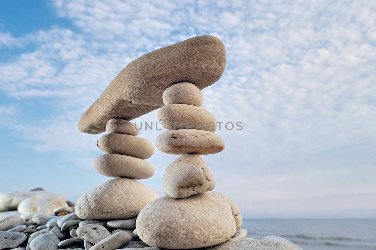 Long horizontal stone between a piles of pebble