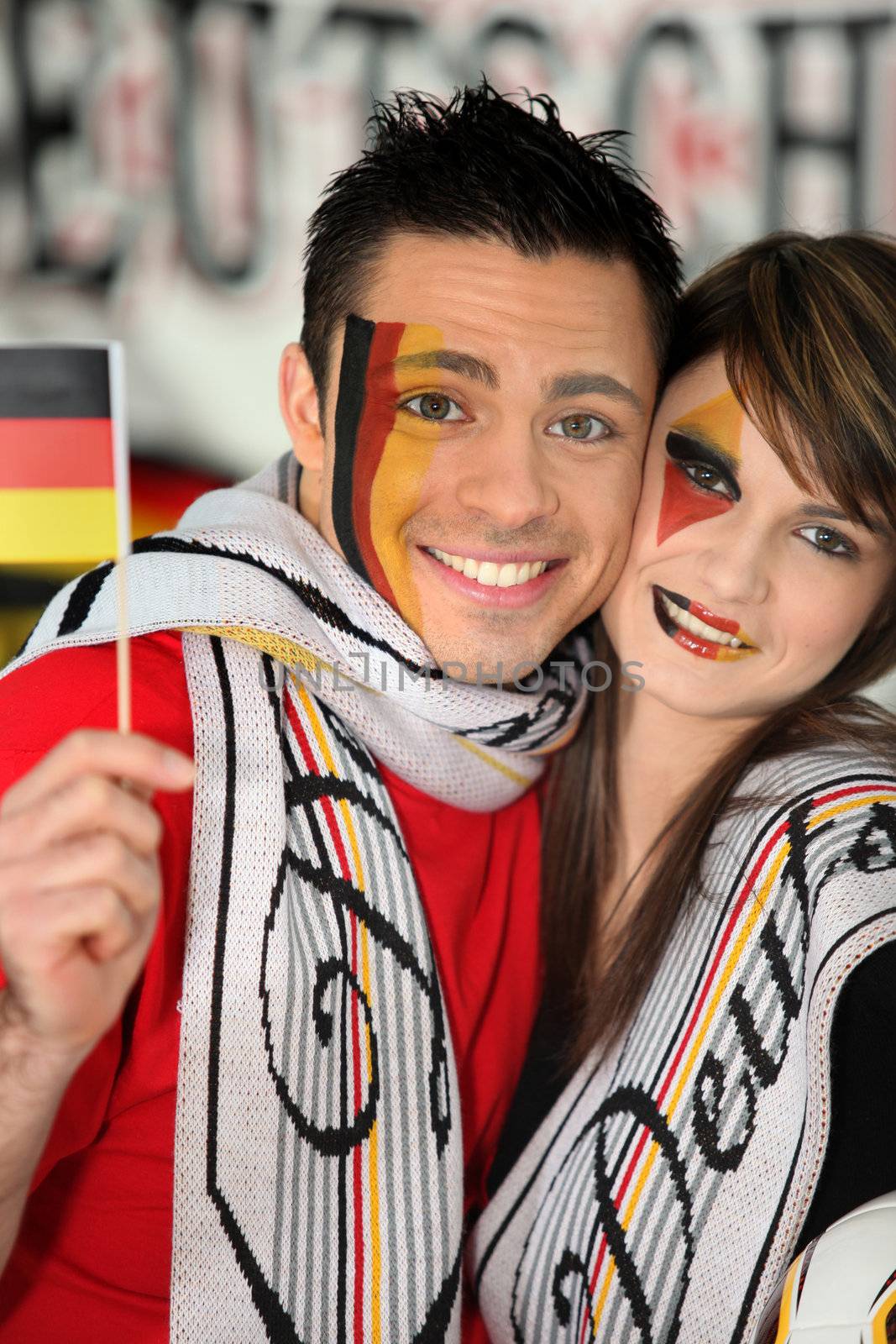 German football fans watching the game on television by phovoir