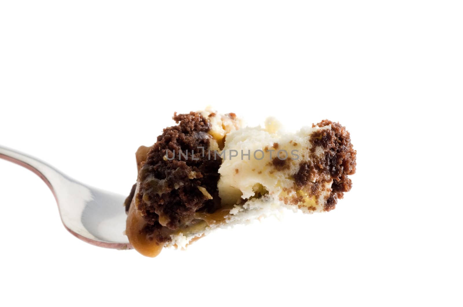 Macro image of a fork full of carmel pecan cheesecake