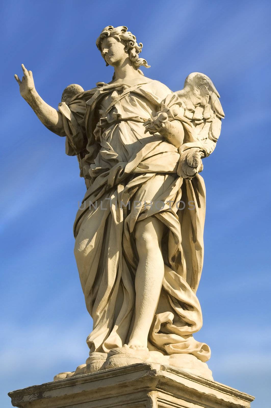 a statue of an angel standing on the bridge leading to the Castle Sant'Angelo, Rome