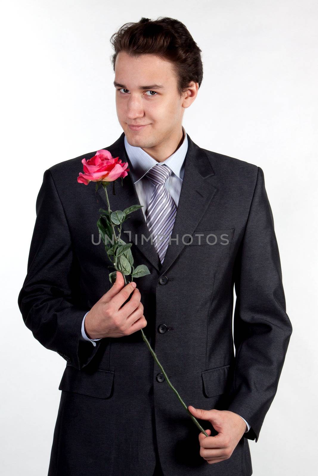 Portrait of a young successful businessman with a flower in your hand