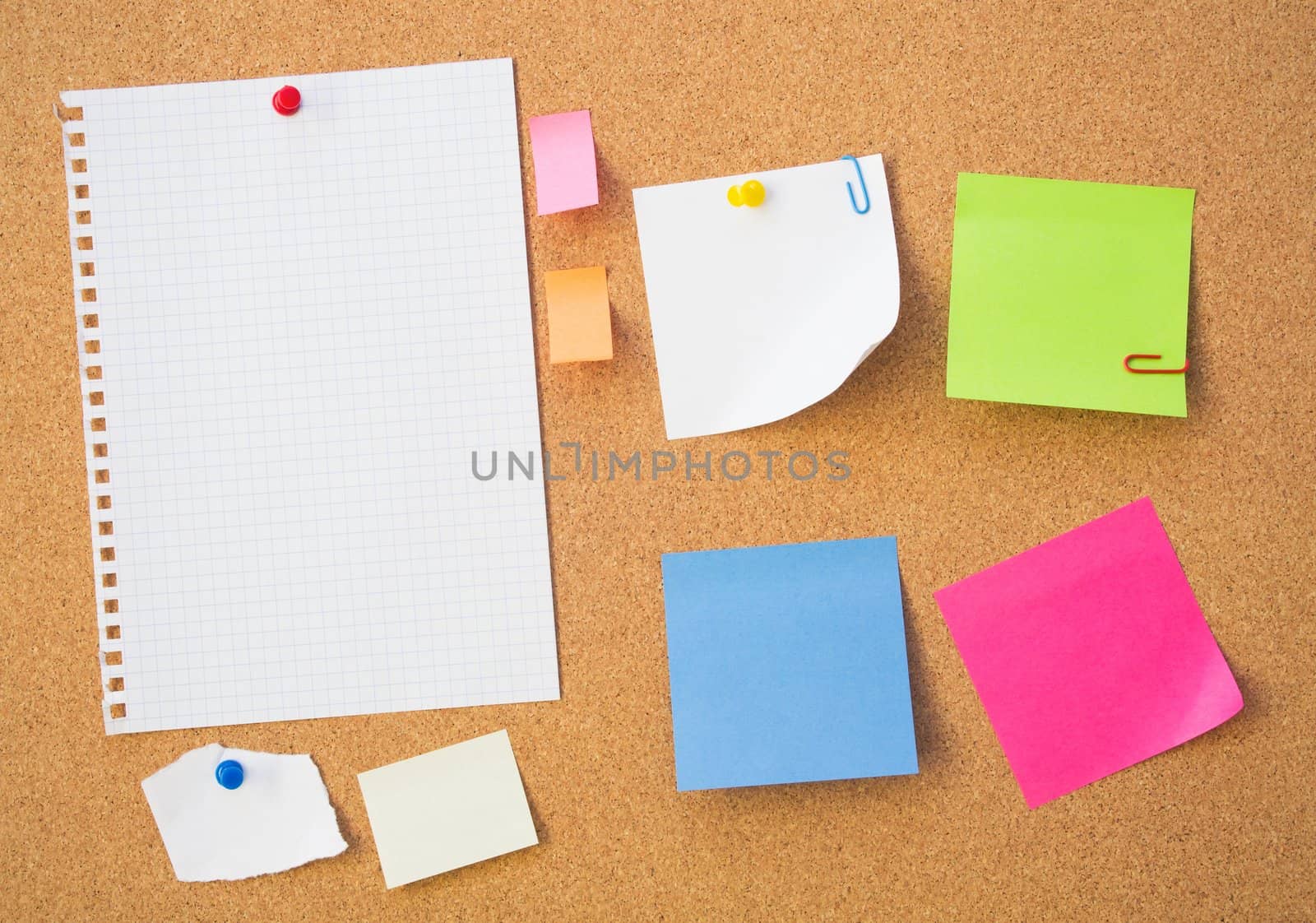 Colour note papers on pin board. Cork background 
