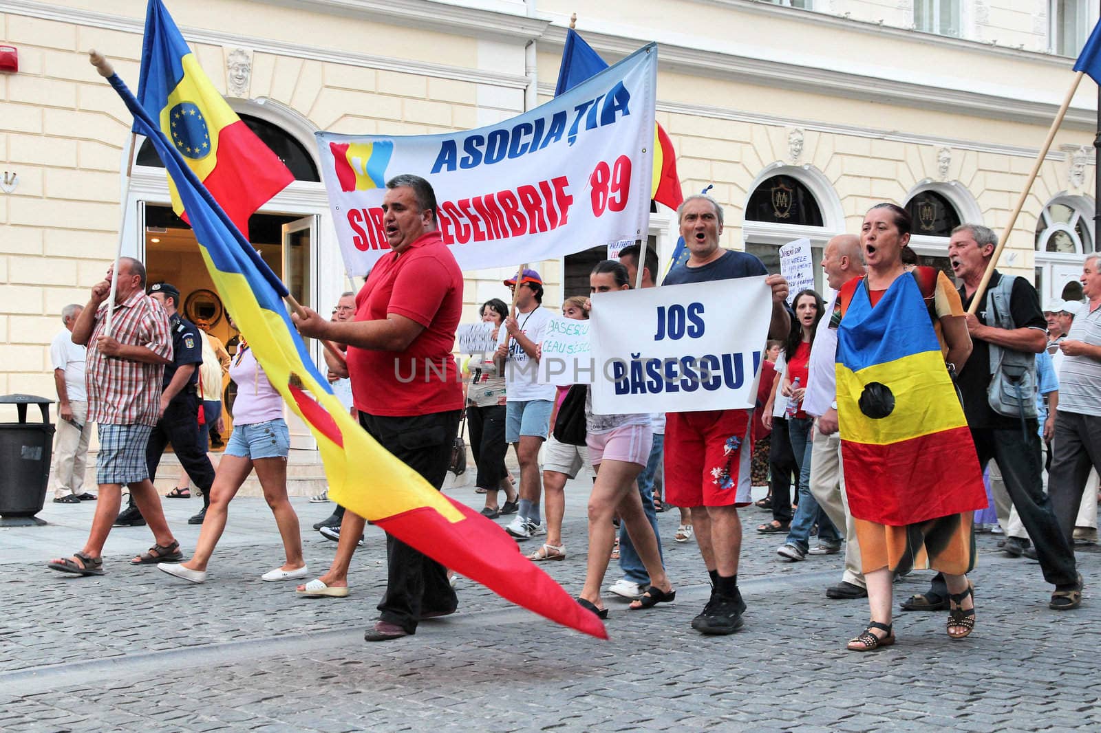 SIBIU, ROMANIA - AUGUST 23: Protesters march on August 23, 2012 in Sibiu, Romania. The protesters are against current president Traian Basescu, they compare him to corrupt communist leader Caucescu.
