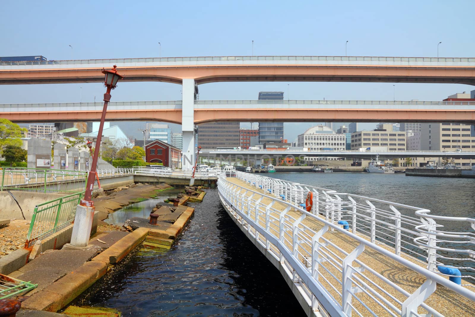 Kobe, Japan - city in the region of Kansai in Hyogo prefecture. Earthquake memorial preserving tilted street lamps and ruined waterfront.