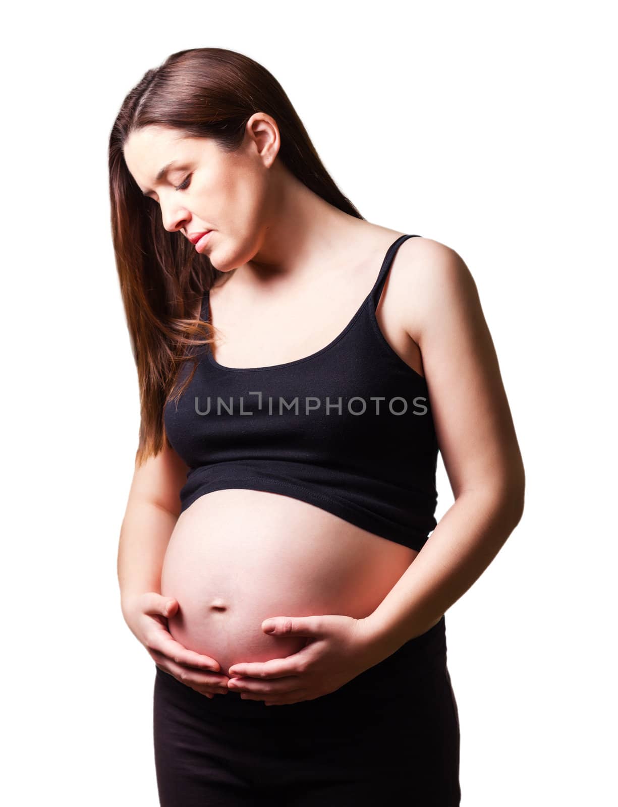 Beautiful pregnant woman looking her belly isolated over a white background