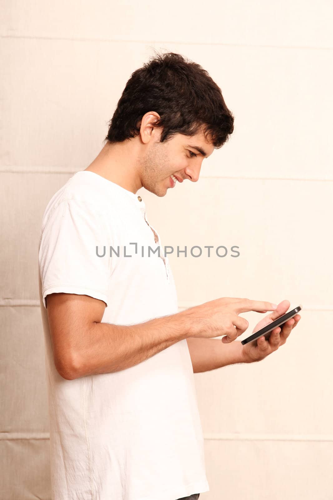 A young hispanic man using a Tablet PC.