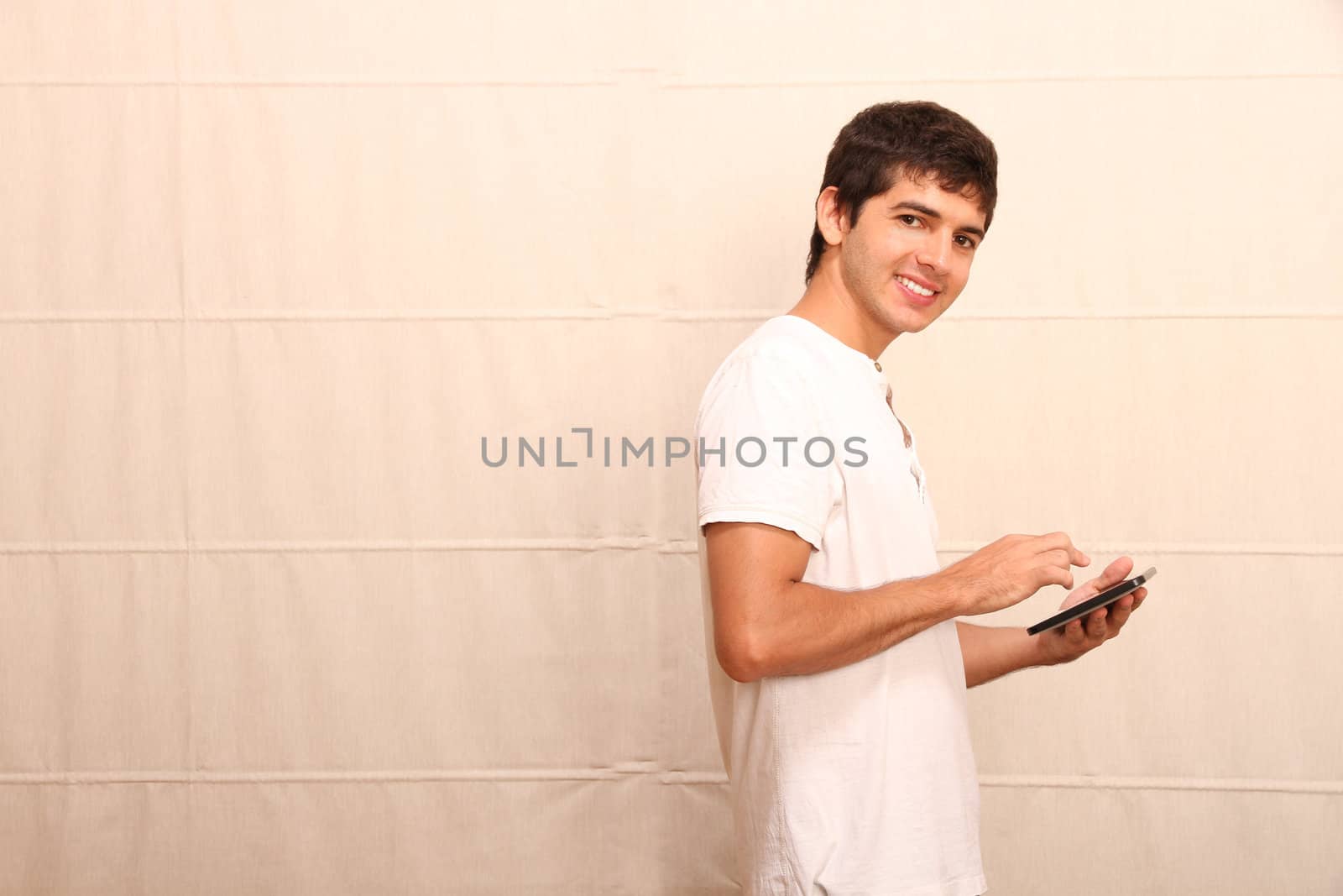 A young hispanic man using a Tablet PC.