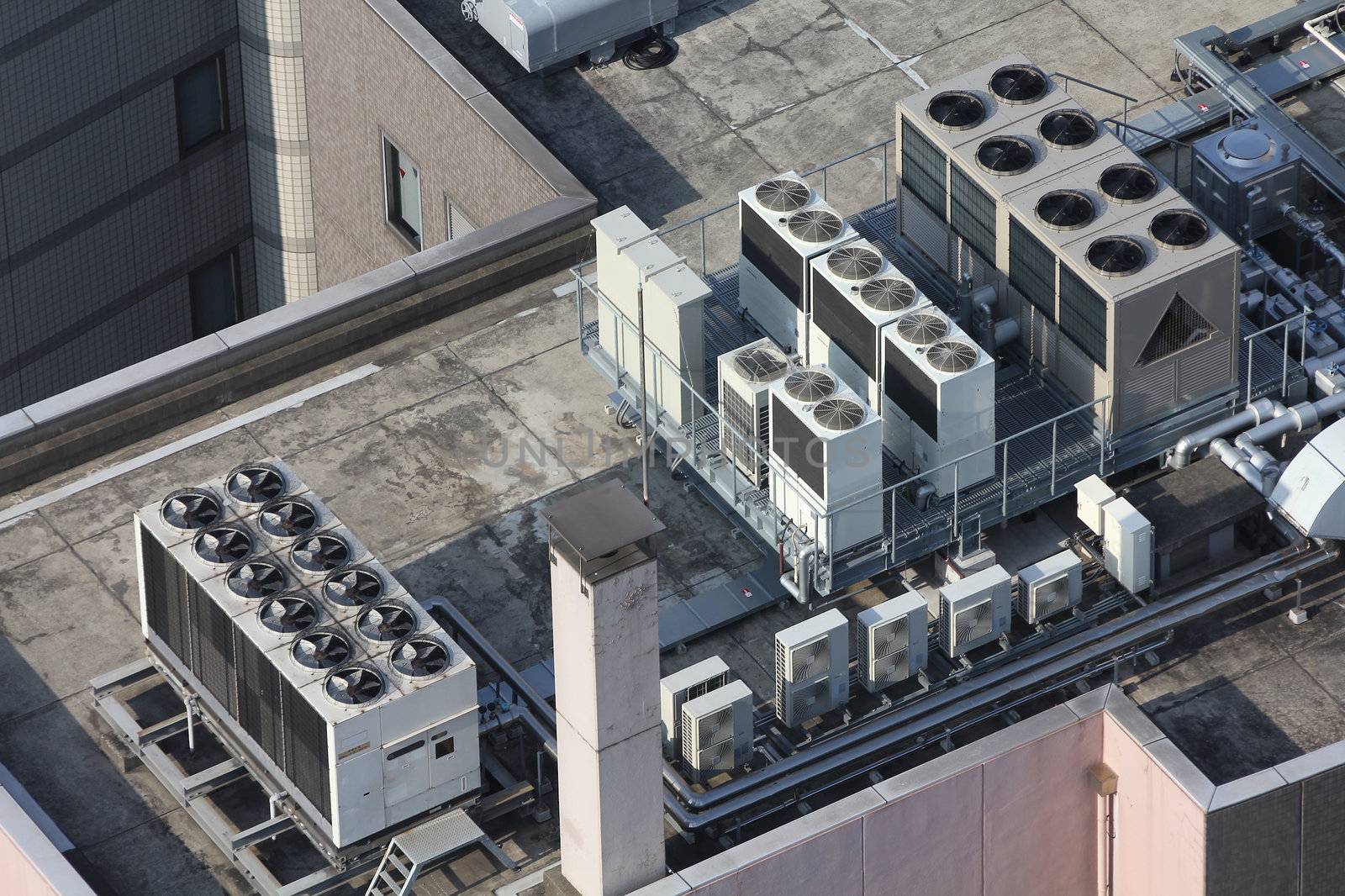 Exhaust vents of industrial air conditioning and ventilation units. Skyscraper roof top in Tokyo, Japan.