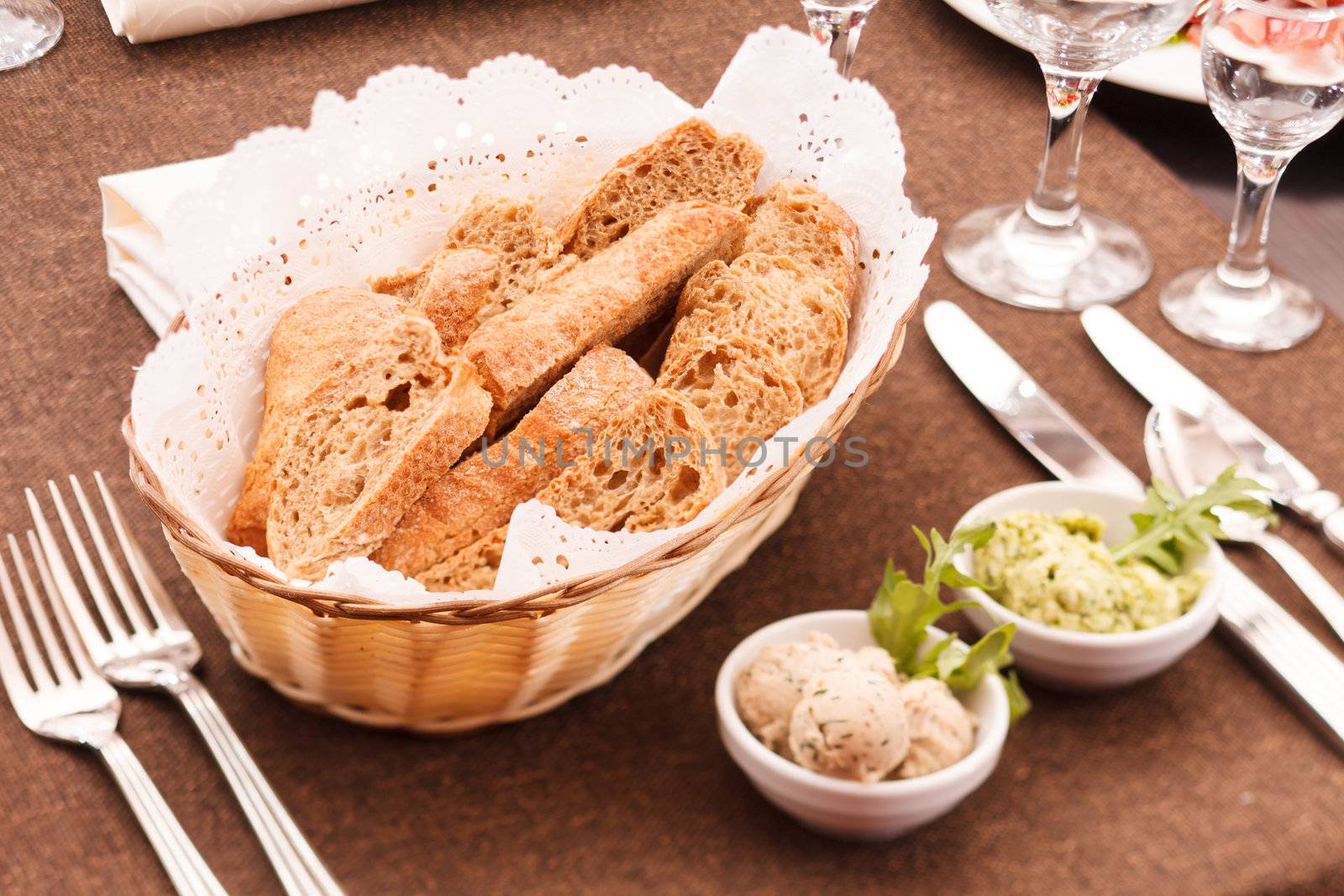  fresh crusty bread in a basket  by shebeko