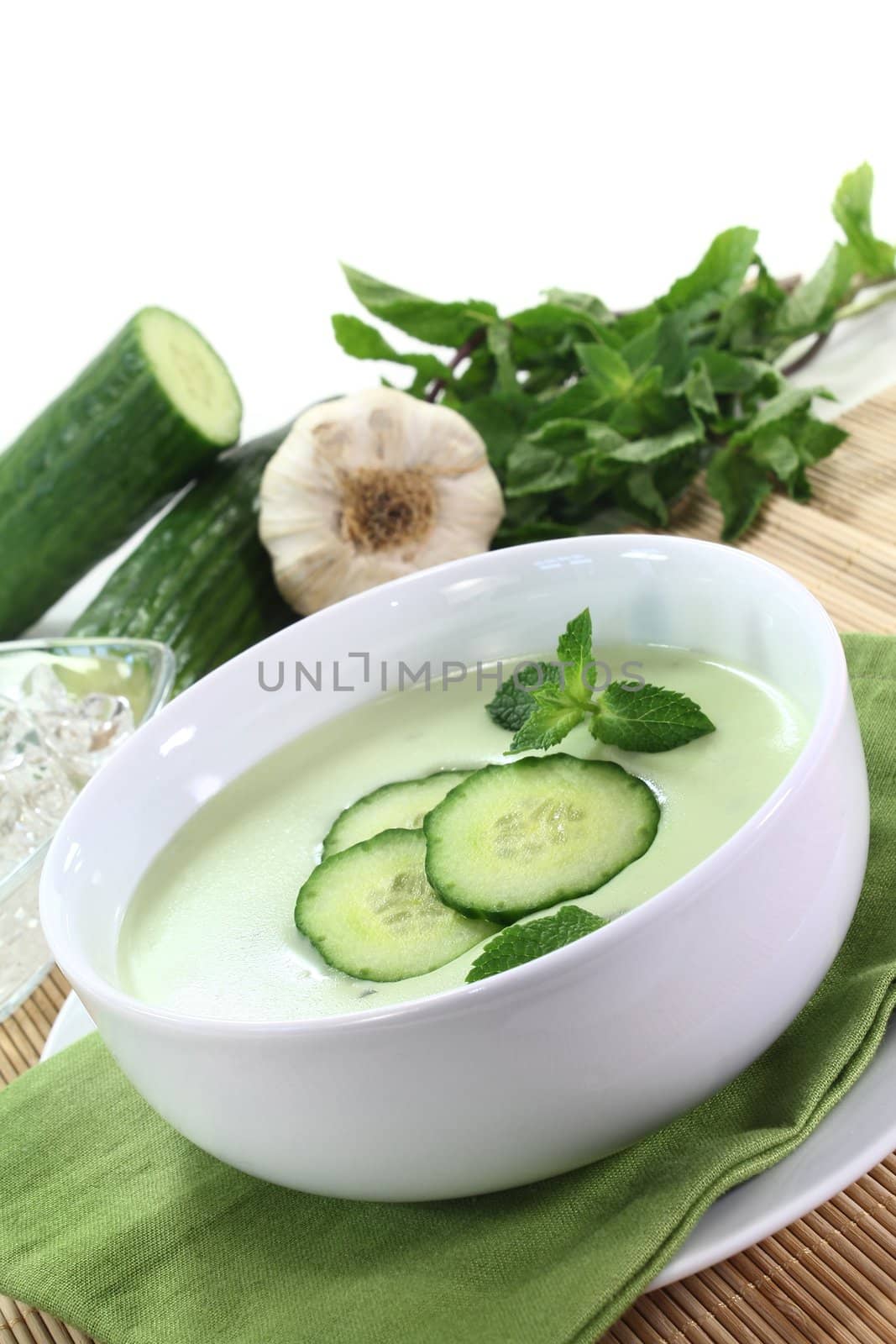 cold cucumber soup with slices of cucumber and mint