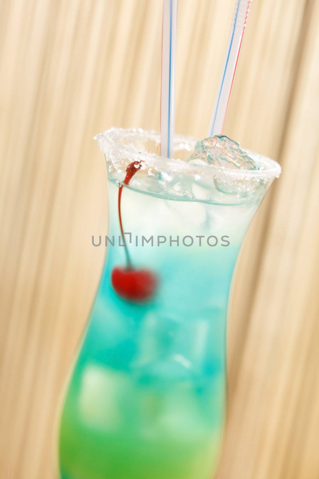 blue cocktail with cherry