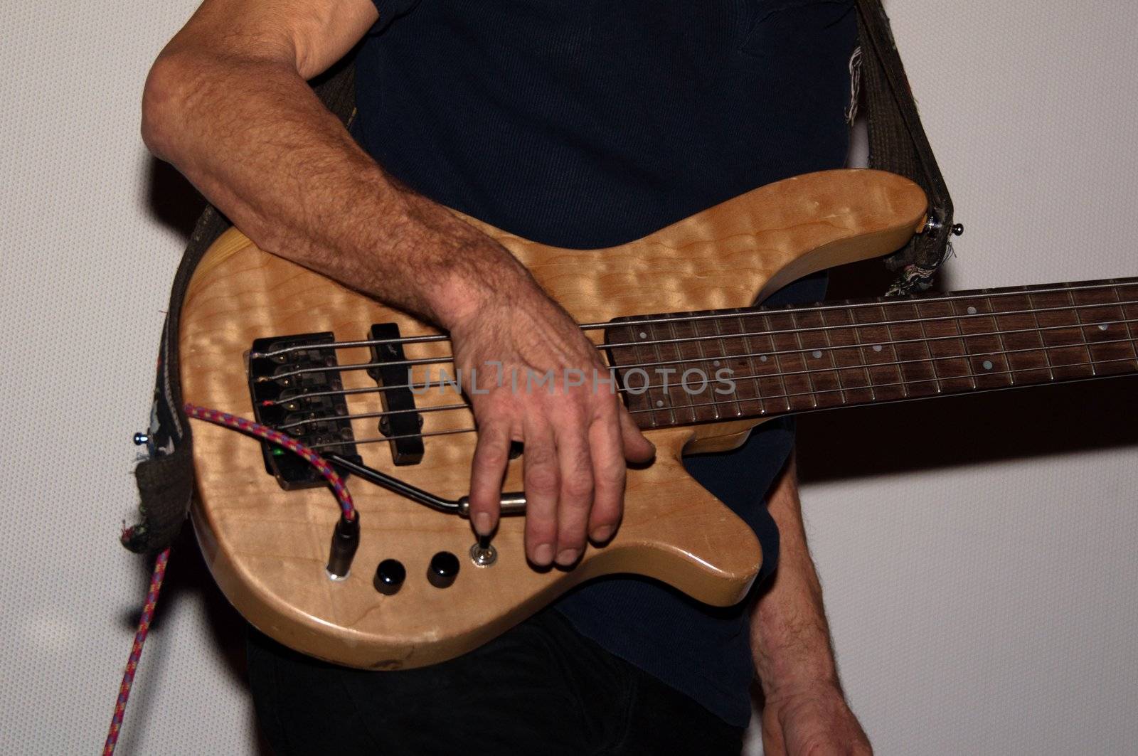 Portrait shot of a bass guitar player with guitar