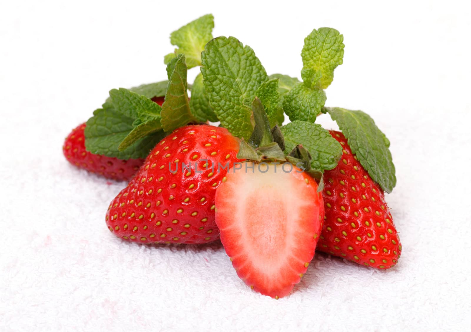Strawberries with mint over white background