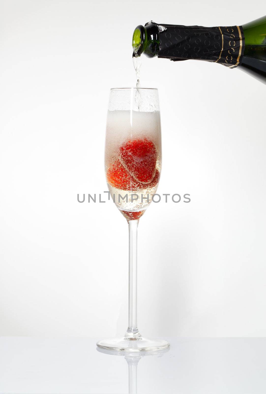 Glasses of sparkling wine and strawberry by Discovod