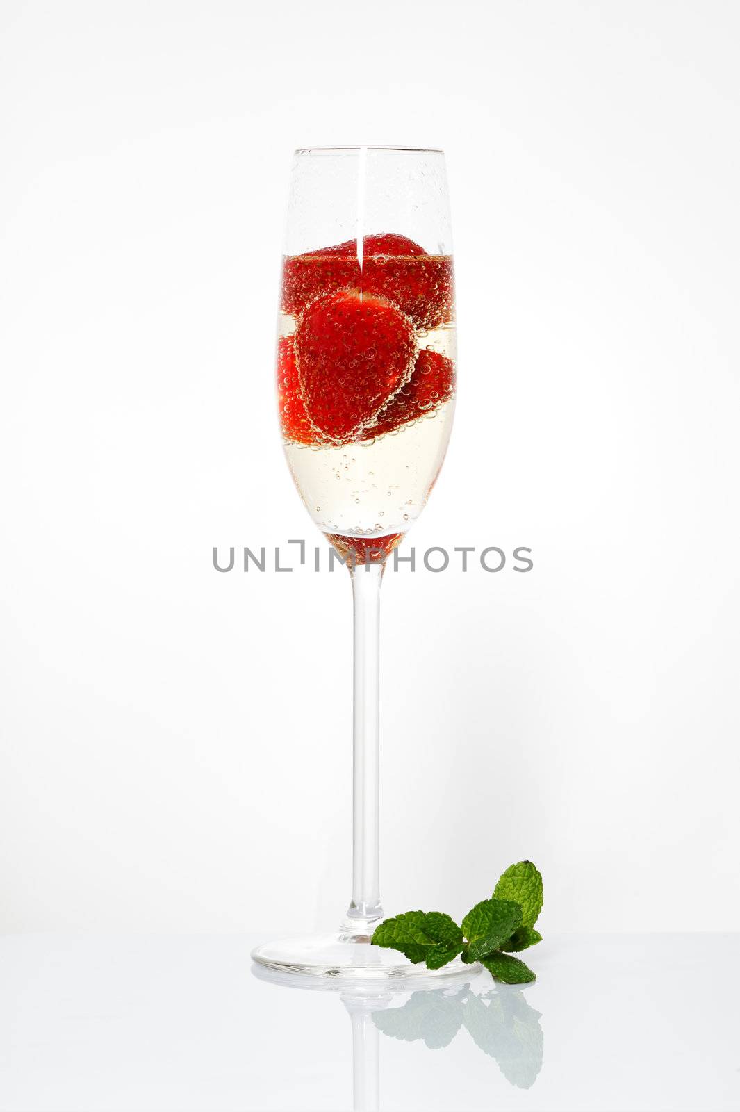 Glasses of sparkling wine and strawberry by Discovod