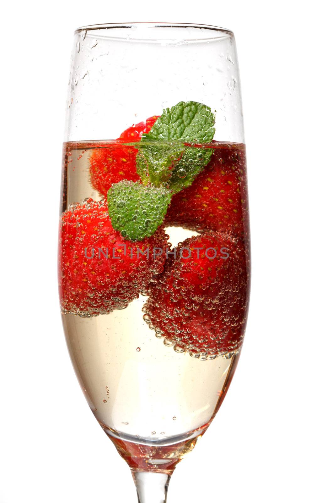 Glasses of sparkling wine and strawberry on white