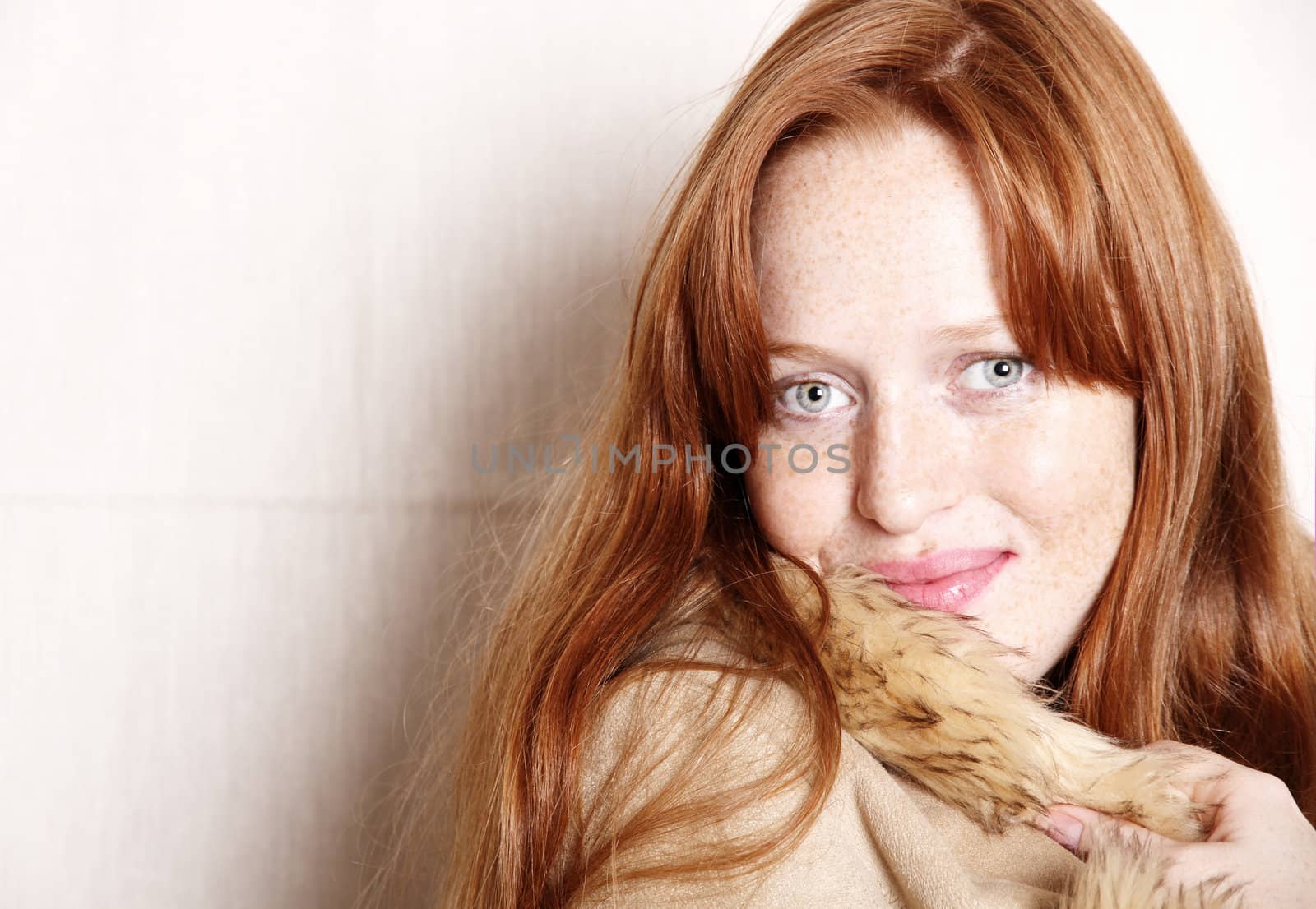 A attractive young, redhead  woman in Winter clothing.  