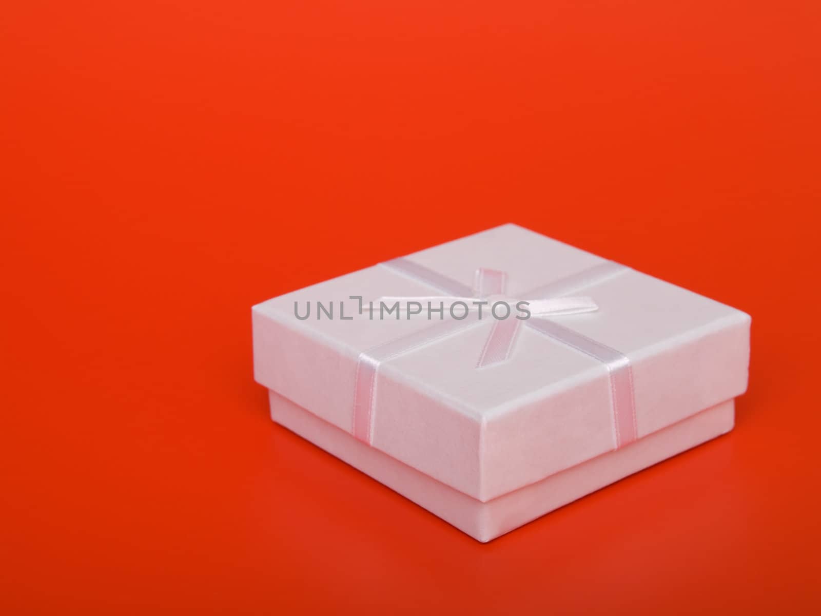 gift box with ribbons, on  red background  