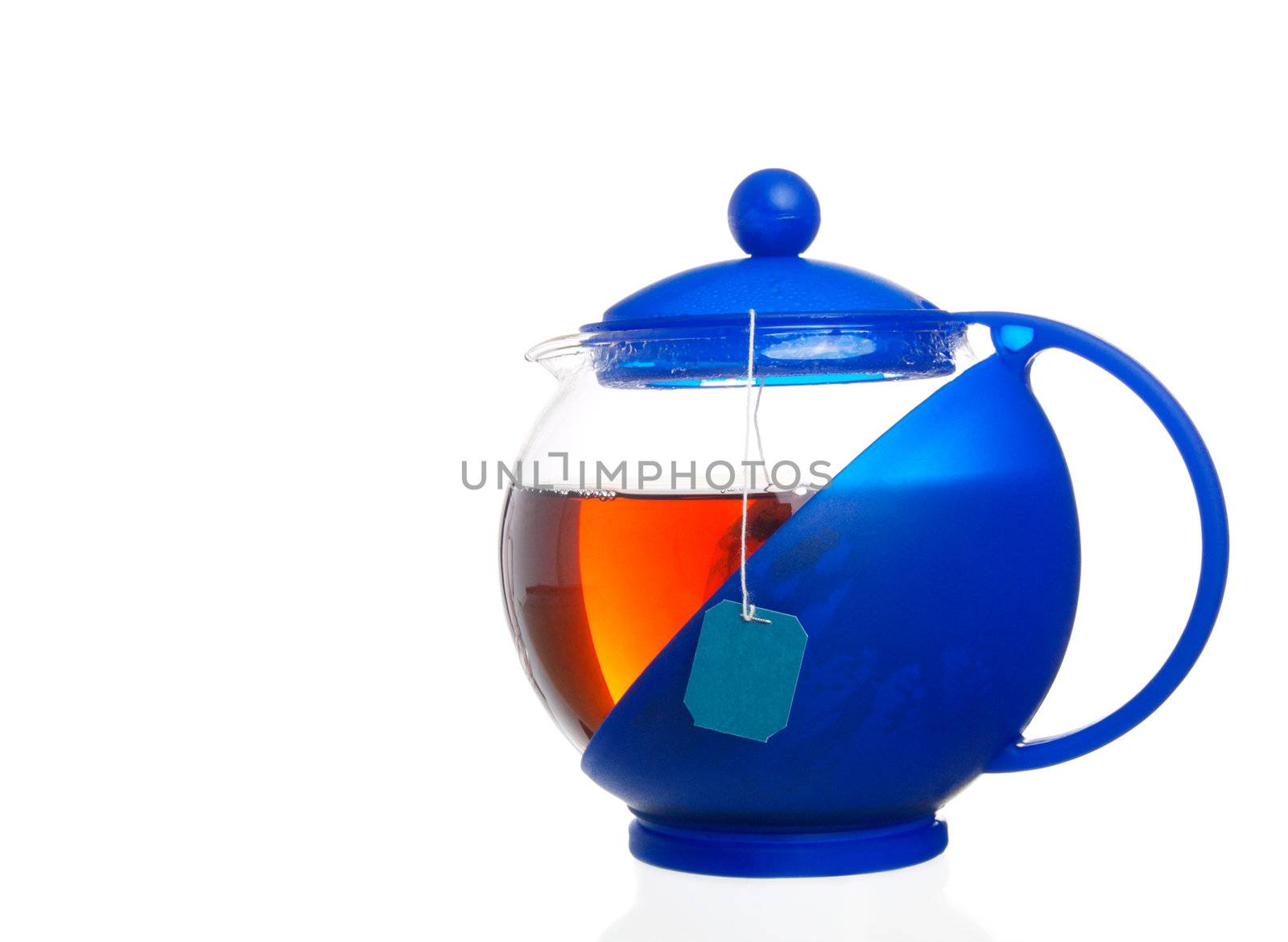 transparent teapot with black tea bag 