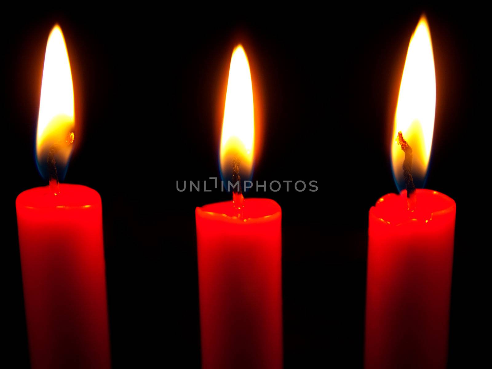 candles flaming in the dark 