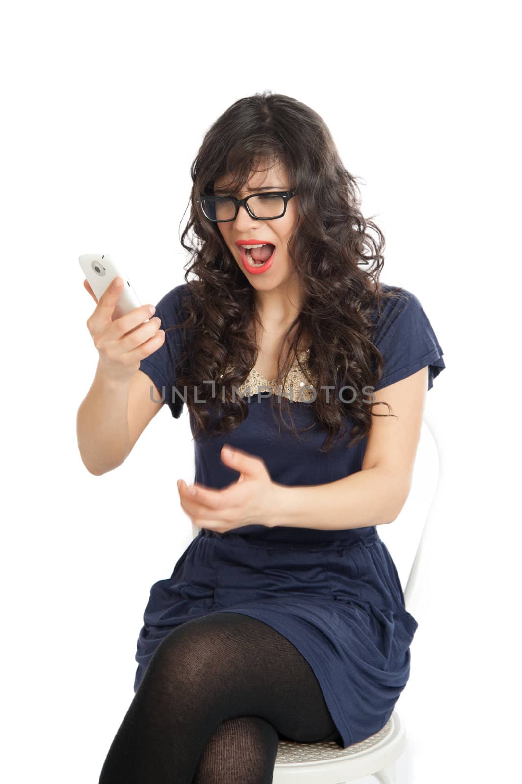 Beautiful woman in glasses shouts displeasure in a mobile phone
