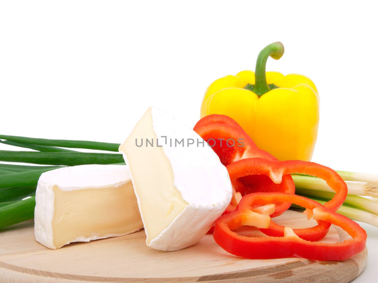 Wheel of French cheese with vegetables (onion, paprika), on white background 
