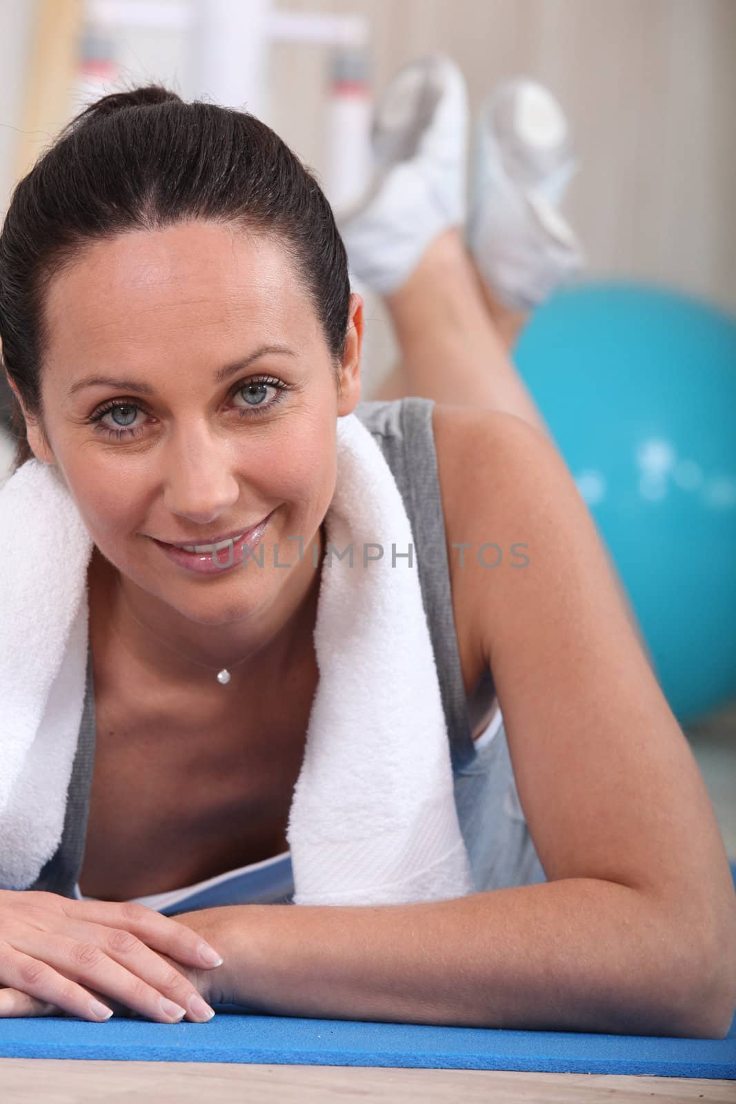 Woman laid on exercise mat