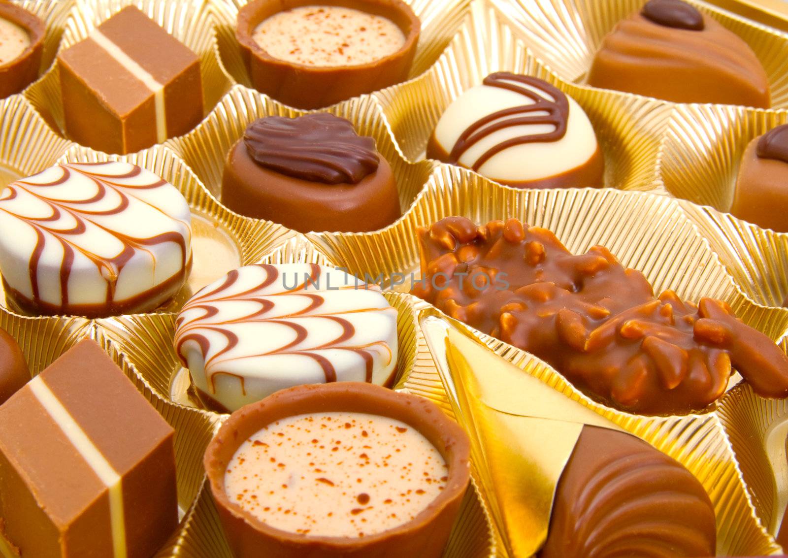 assortment chocolate pralines in a golden box