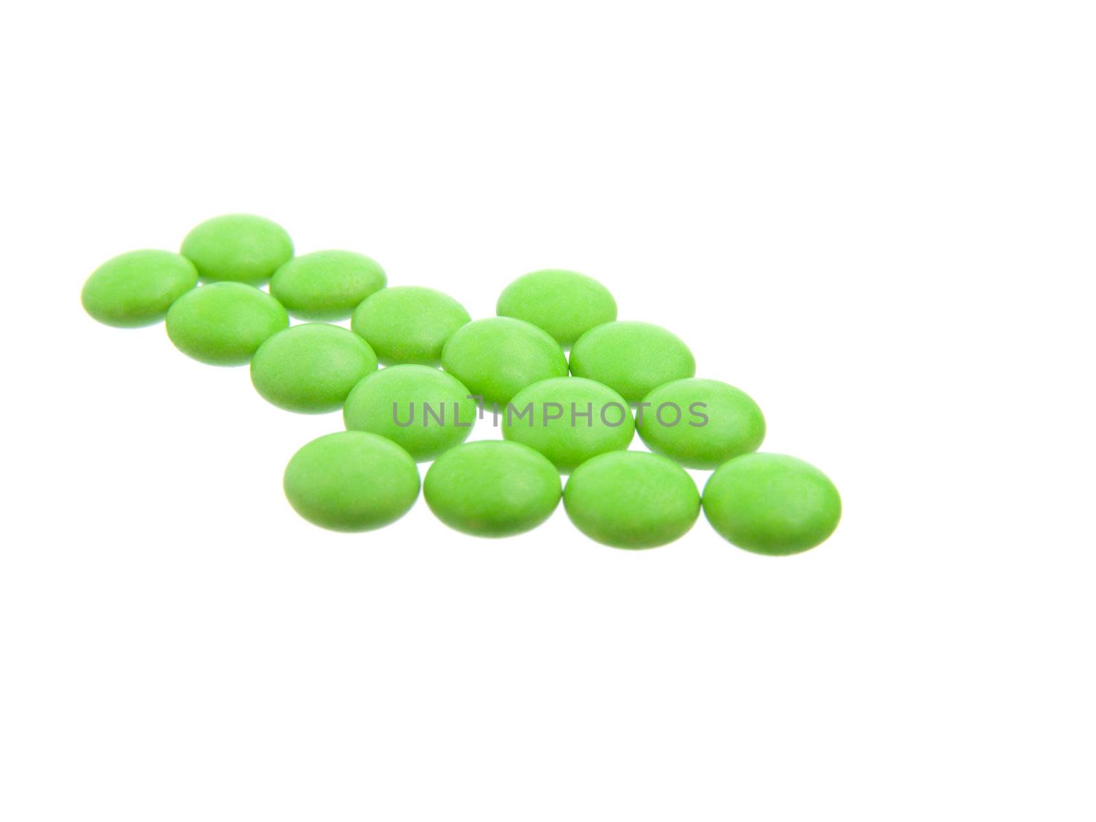 green tablets in arrow formation, isolated on white background 