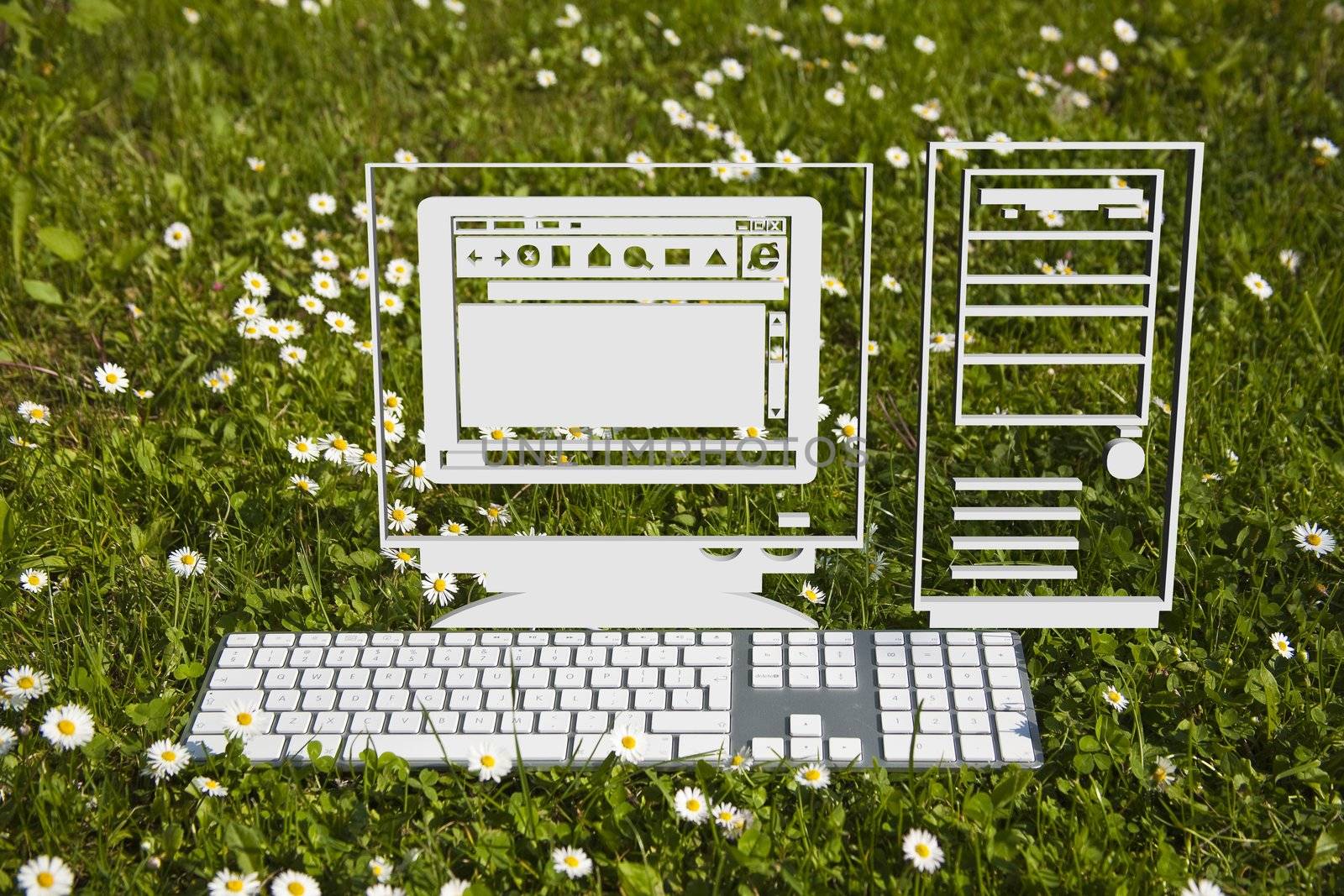 Virtual computer hardware and modern keyboard on green grass in garden